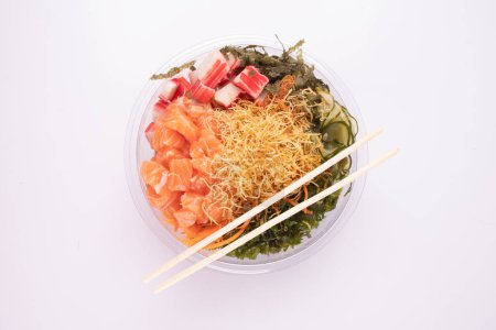 Foto de Oriental japonés comida poke y kani aislado en blanco fondo crudo salmón vista superior con un par de palillos - Imagen libre de derechos