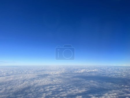 flying over the clouds with blue sky