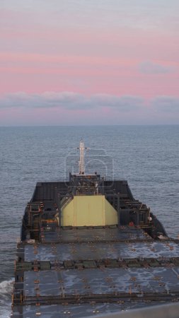 Photo for View from the wheelhouse on the deck and LNG tank located on the fore part of the empty container vessel. Container ship in ballast condition during sea passage in the North sea. - Royalty Free Image