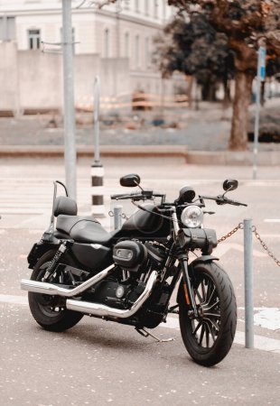 A black modern motorcycle is parked on the street next to a pedestrian cross. Prohibited parking of the vehicles. Parking violations.