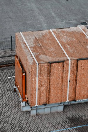 Photo for A wooden box with important cargo inside loaded onto a container fur further sustainable efficient safe shipping within the world. Types of cargo. Packed and secured cargo inside the plywood box. - Royalty Free Image