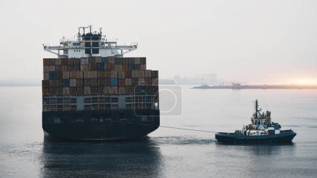 Photo for Towing Process Of The Fully Loaded Deep Draught Container Vessel In The Port - Royalty Free Image