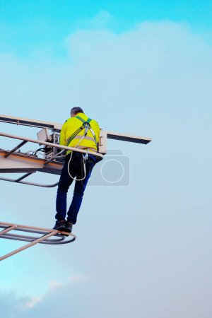 Photo for Radar Magnetron Exchange Process. Marine Radar Maintenance. Technician On The Mast Wearing A Life Vest And Makes Inspection And Performance Test Of The Gear. Concept Of Safety While Working Aloft - Royalty Free Image