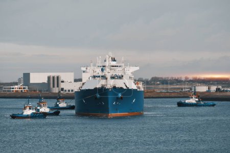 Photo for LNG Tanker Mooring In The International Trade Port. Gas Transportation Facility. Natural Gas Shipping And Logistics - Royalty Free Image