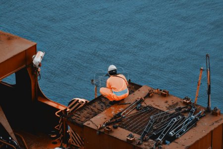 Maintenance System On Deck. Seafarer At Work During His Rest Hours. Overtime Duties In The Offshore Industry