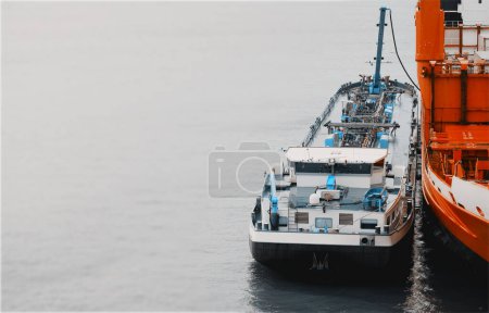 Photo for Ship-To-Ship STS Bunkering Operations In The Port With Marine Loading Arm - Royalty Free Image