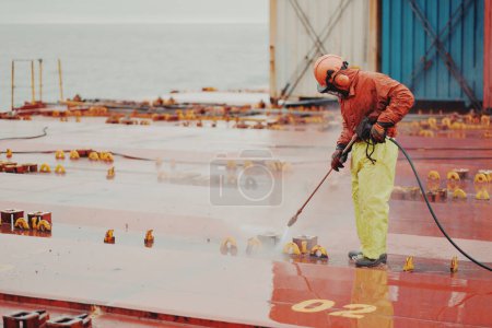 Seaman Seafarer In Safety Clothes Working On Deck Hatch Holding 