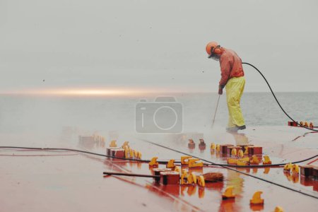 Seaman Seafarer In Safety Clothes Working On Deck Hatch Holding 