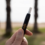Tarragona, Spain - October 29, 2022: Phillip Morris Internationals Marlboro IQOS, electronic cigarette in a mans hand.