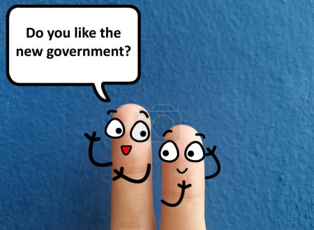 Foto de Dos dedos están decorados como dos personas. Están discutiendo sobre las elecciones. Uno de ellos pregunta al otro si le gusta el nuevo gobierno.. - Imagen libre de derechos
