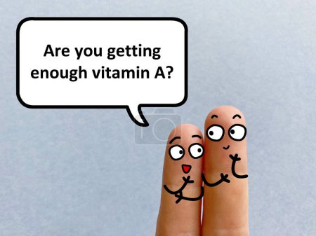 Photo for Two fingers are decorated as two person. They are talking about health problem. One of them is asking another if he is getting enough vitamin A. - Royalty Free Image