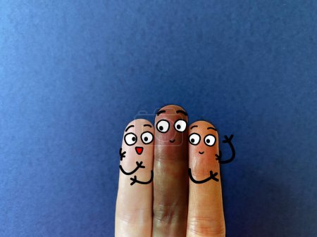 Photo for Three fingers are decorated as three person. They have different skin color. - Royalty Free Image