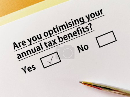 Photo for A person is answering question about business. He is optimising his annual tax benefits. - Royalty Free Image