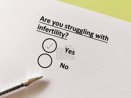 Foto de One person is answering question about infertility. She is struggling with infertility. - Imagen libre de derechos