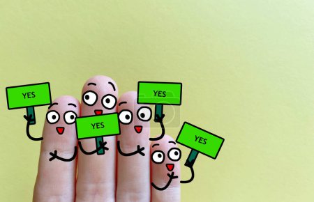 Photo pour Four fingers are decorated as four person. All of them say yes. - image libre de droit