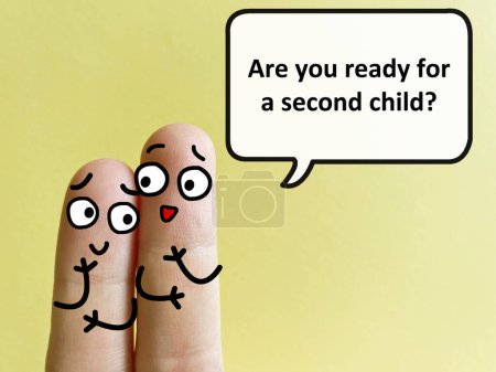 Téléchargez les photos : Two fingers are decorated as two person. One of them is asking another if she is ready for a second child. - en image libre de droit