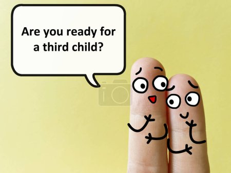 Téléchargez les photos : Two fingers are decorated as two person. One of them is asking another he is ready for a third child. - en image libre de droit