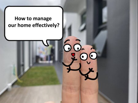 Téléchargez les photos : Two fingers are decorated as two person standing outside a new house. One of them is asking another how to manage his home effectively. - en image libre de droit