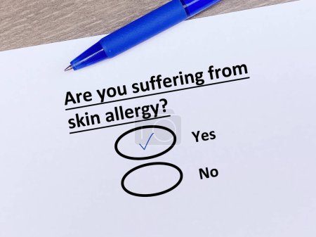 Photo for A person is answering question about illness. She is suffering from skin allergy. - Royalty Free Image