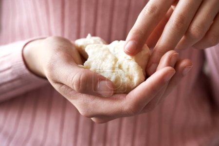 Photo for Hands holding raw unrefined shea butter or karite - Royalty Free Image