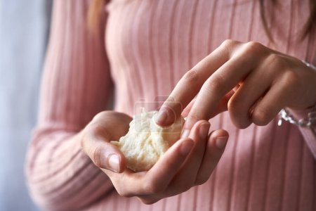 Photo for Teenage girl holding a piece of raw unrefined shea butter or karite in her hands - Royalty Free Image