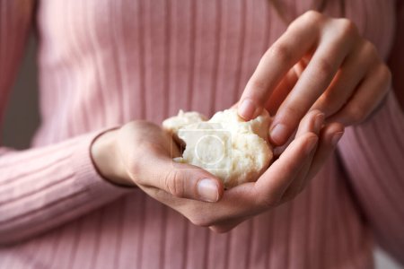 Photo for Woman's hands holding raw unrefined shea butter or karite - Royalty Free Image