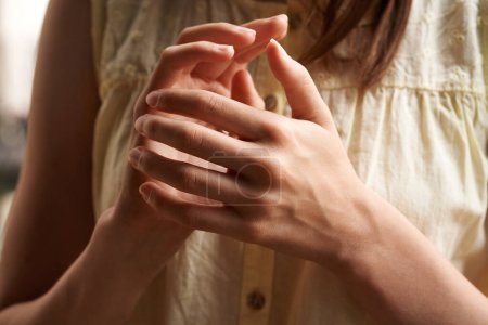Hands of a teenage girl practicing EFT tapping or emotional freedom technique