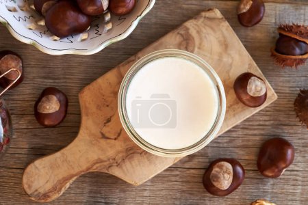 Photo for Horse chestnut ointment in a glass jar on a table, top view - Royalty Free Image