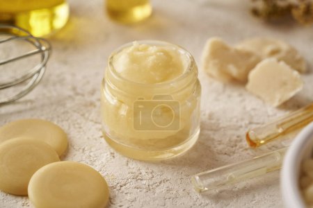 Photo for Homemade cosmetic cream made of shea butter, cocoa butter and essential oils - Royalty Free Image