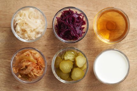 Fermented foods and vegetables - kimchi, white and purple sauerkraut, apple cider vinegar, gherkins and kefir, top view
