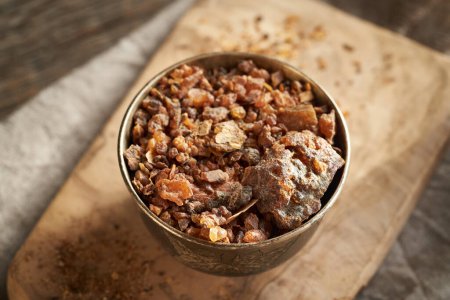 Myrrh resin in a metal bowl - ingredient for essential oils