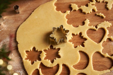 Photo for Cutting out shapes from rolled out dough to prepare traditional Linzer Christmas cookies, close up - Royalty Free Image