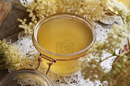 Photo for Homemade elderberry flower syrup in a glass jar on a table - Royalty Free Image