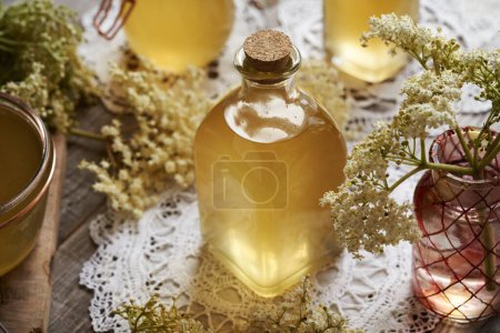 Photo for Homemade elderberry flower syrup made in spring in a glass bottle - Royalty Free Image