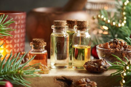 Christmas essential oils with myrrh, frankincense resin and spruce tree branches