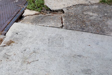 Photo for Concrete sidewalk and metal plate, deep cracks and dangerous shifting between sidewalk segments, creative copy space, horizontal aspect - Royalty Free Image