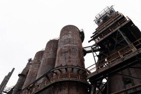 Oblique view of abandoned steel mill blast furnaces and attendant structures, horizontal aspect
