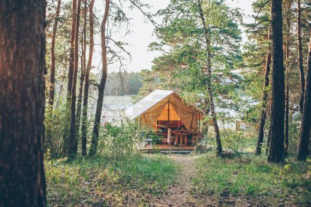 Glamping tent. Glamping travel. Tent house in forest. Camping and vacation outdoor concept.