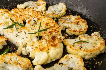 Photo for Fried Cauliflower Slices Closeup, Baked Cauliflower Steaks, Roasted Cabbage Steak with Herbs - Royalty Free Image