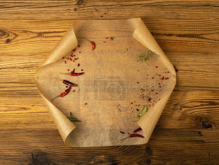 Téléchargez les photos : Brown Baking Paper with Herbs and Spices, Kraft Cooking Paper Sheet on Wooden Texture Background, Bakery Parchment Mockup, Greaseproof Baking Paper Top View - en image libre de droit