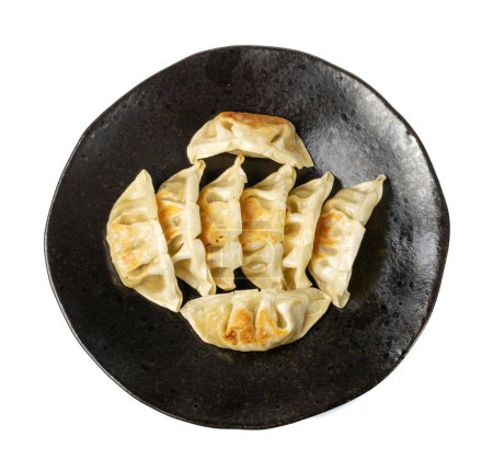 Photo for Gyoza Chinese Dumplings Isolated, Fried Vegetable Jiaozi, Chicken Momo Pile, Asian Gyoza Group on Black Plate, White Background Top View - Royalty Free Image