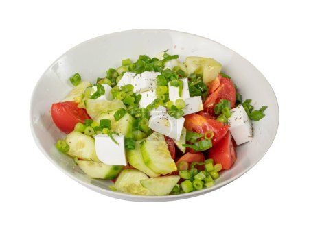 Foto de Greek Salad Isolated, Horiatiki Salat with Tomatoes, Cucumbers, Onion, Feta Cheese in White Bowl, Village Salad with Diced Mozzarella, Parsley, Greens and Olive Oil - Imagen libre de derechos