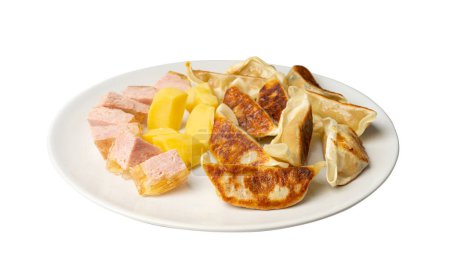 Photo for Gyoza Chinese Dumplings on White Plate, Fried Vegetable Jiaozi with Boiled Potatoes and Canned Meat - Royalty Free Image