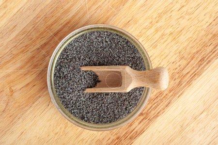 Photo for Poppy Seed in Bowl, Blue Poppyseed Pile in Wood Spoon, Small Culinary Grains, Tiny Seeds, Oilseed Sprinkles for Cooking, Poppy Seed on Wooden Rustic Background - Royalty Free Image
