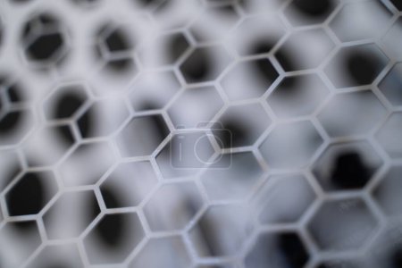 Photo for Close-up of the honeycomb-like carbon grid. car parts bokeh light background. - Royalty Free Image