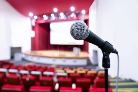 Close-up shot of microphone in banquet hall auditorium.