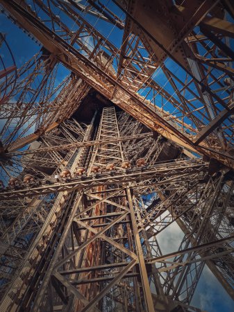 Photo for Eiffel Tower architecture details Paris, France. Underneath the metallic structure, steel elements with different geometric shapes - Royalty Free Image