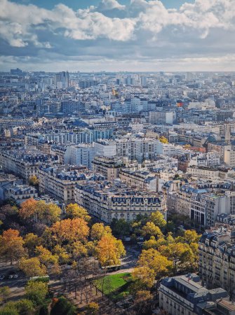 Photo for Paris cityscape vertical view from the Eiffel tower height, France. Fall season scene with colored trees - Royalty Free Image