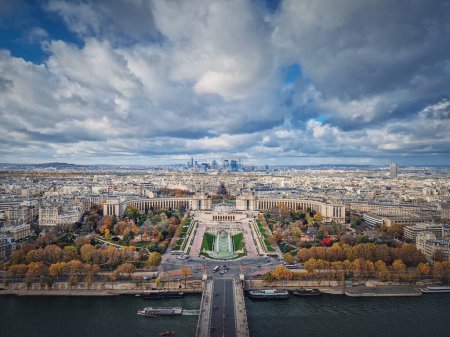 Photo for Aerial panoramic view from the Eiffel tower height to the Paris cityscape, France. Seine river, Trocadero area and La Defense metropolitan district seen on the horizon - Royalty Free Image