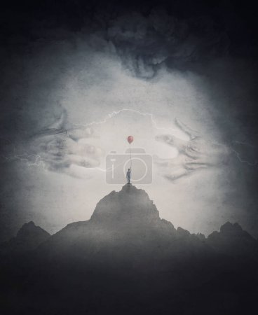 Foto de Spooky scene with a lone boy holding a red balloon on top of a mountain facing a mysterious creature with giant scary hands coming out of the fog. Fantasy adventure and thrill background - Imagen libre de derechos